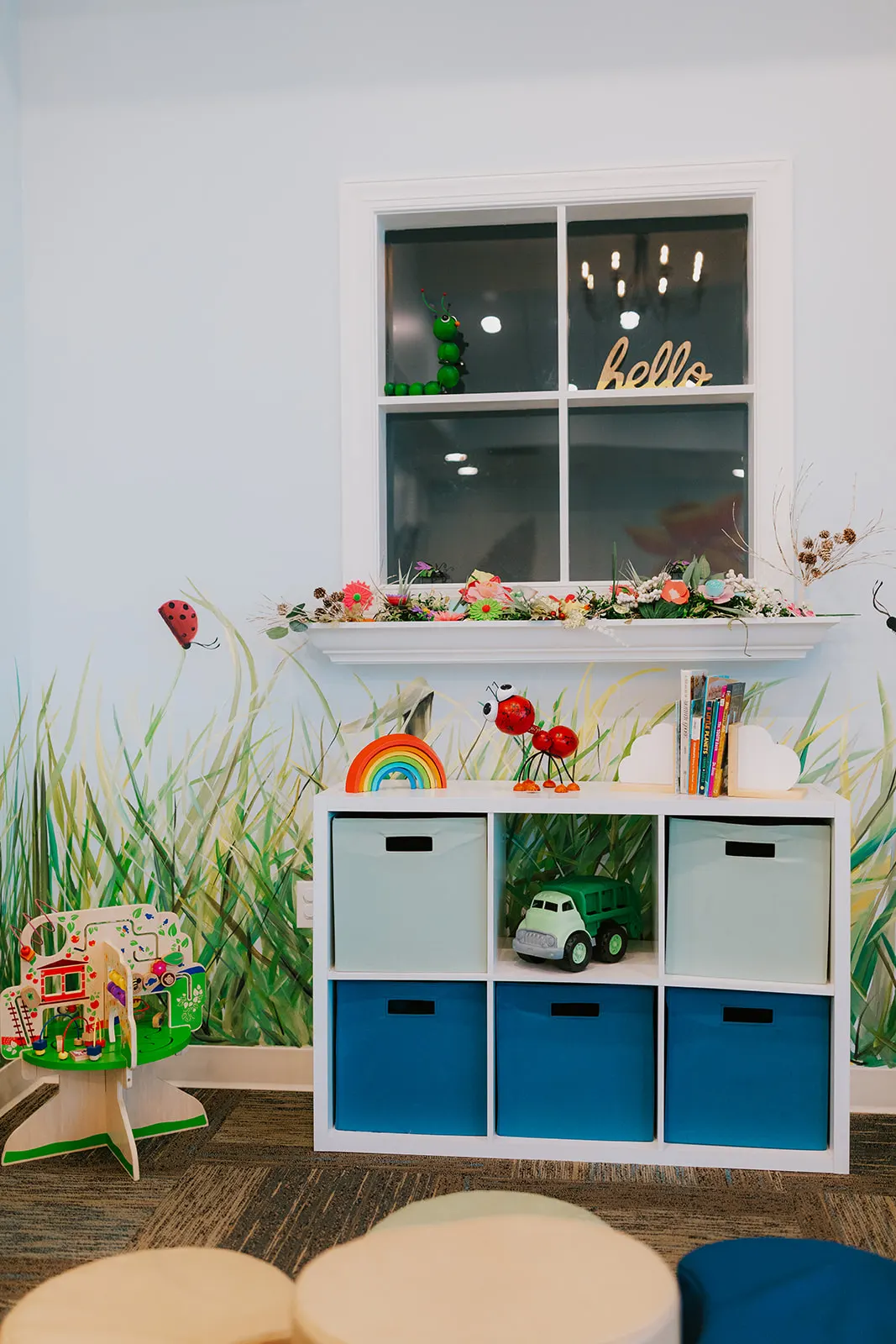 Toy storage cubbies and books beneath the